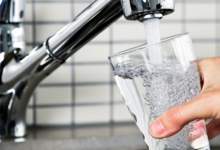 Glass of water being filled from tap.