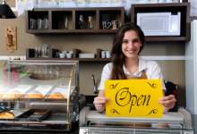 Businesswoman holding a sign that says open