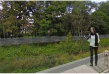 Image of a woman walking her dog along Rennies River