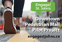image shows person walking on water street at the pedestrian mall