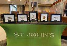 image shows 5 awards on a green table with the city logo